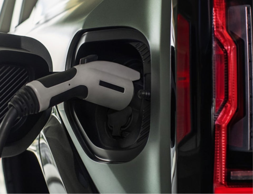 Close up of charging port with charger plugged in on a GMC Hummer EV SUV - Lake GMC in Devils Lake ND
